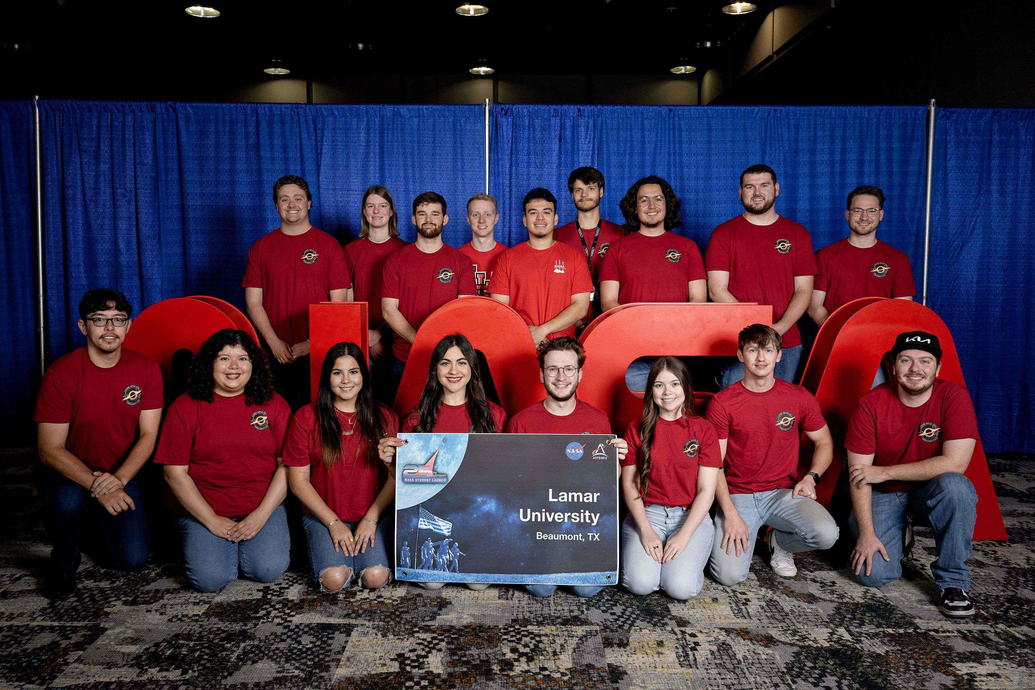 LUNAR team members gathered for a team photo at a rocketry event.