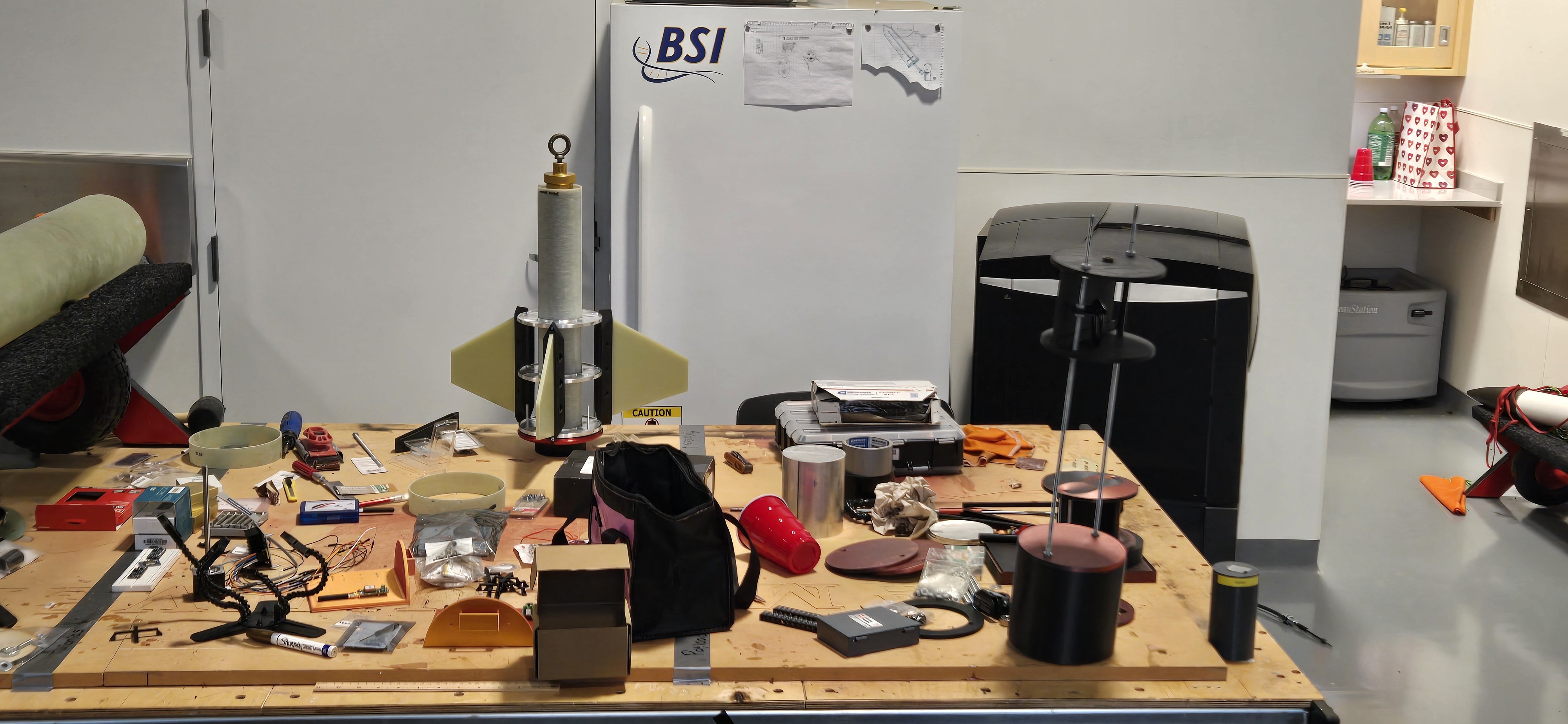 Rocket components and prototypes arranged in the LUNAR workshop.