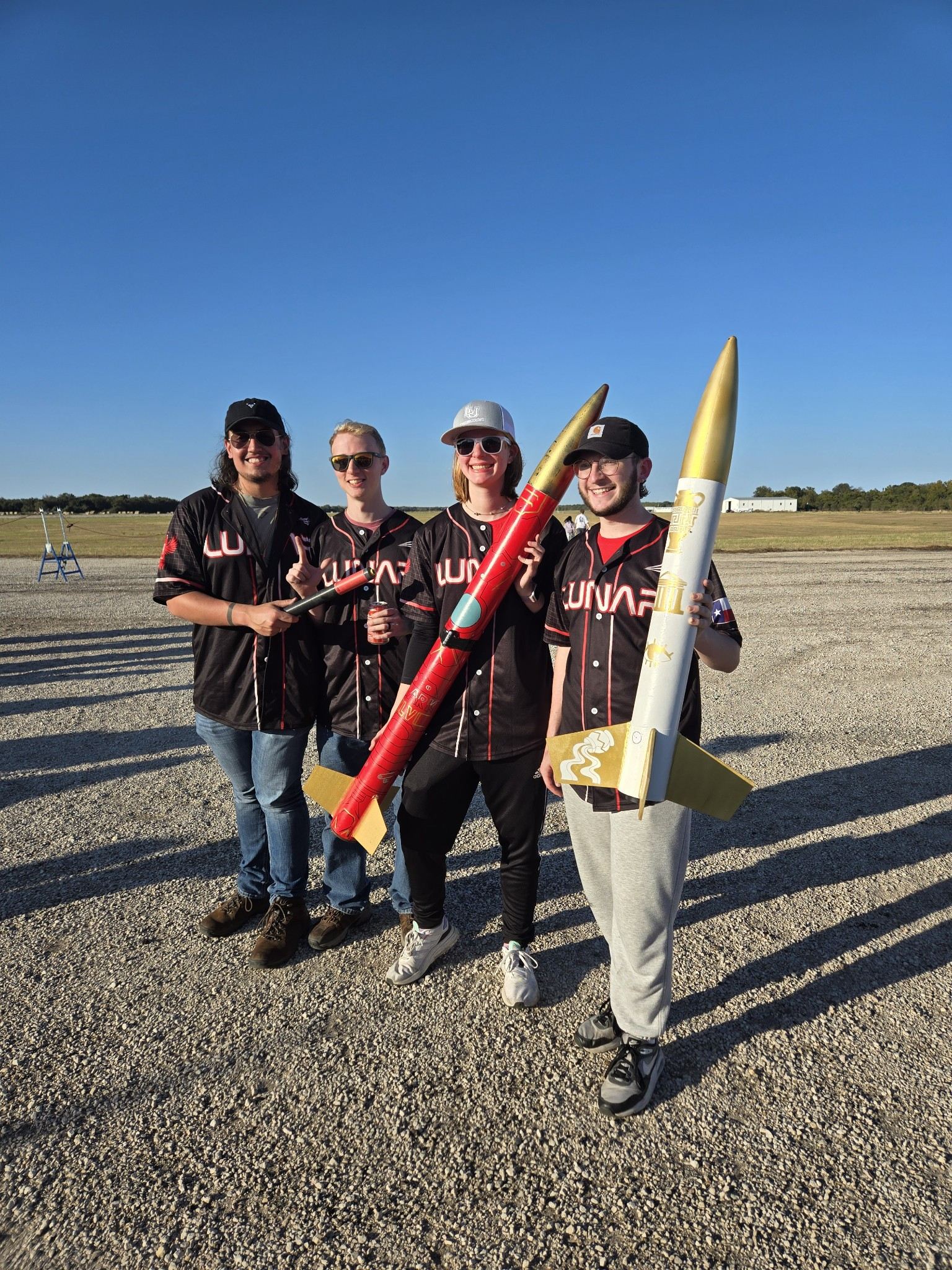 LUNAR members posing with their rockets after launch-day operations.
